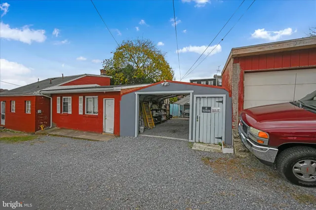 a view of a patio with table and chairs with wooden floor and fence