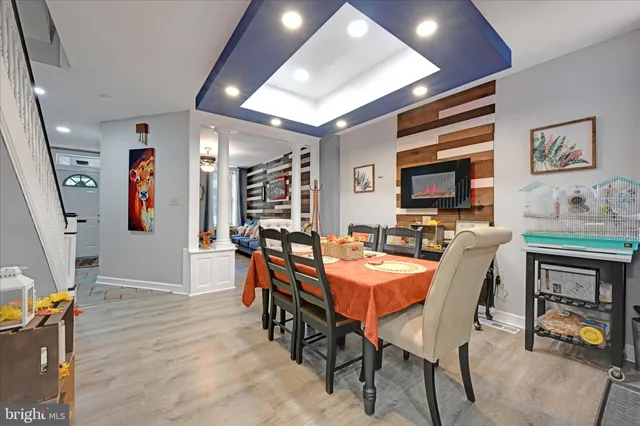a view of a dining room with furniture and a flat screen tv
