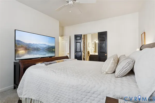 a bedroom with a bed and a flat screen tv