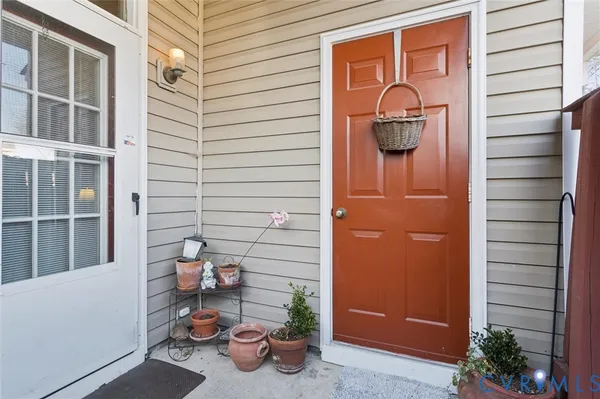 a view of a door and chair in the patio