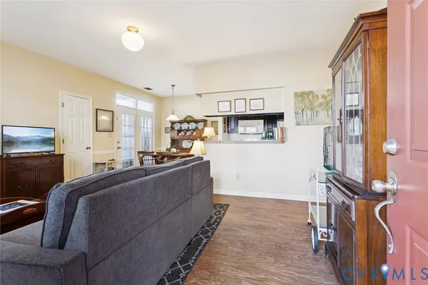 a living room with a couch and a refrigerator