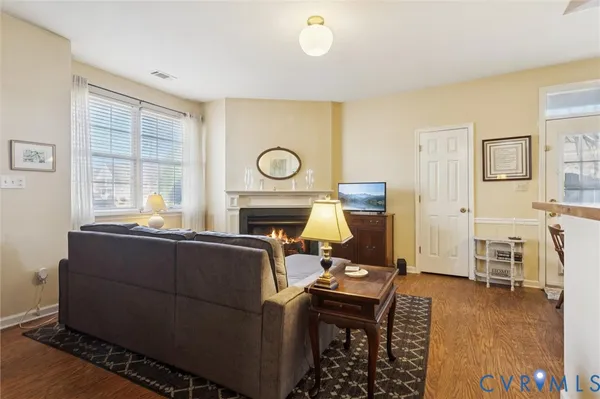 a living room with furniture a fireplace and a table