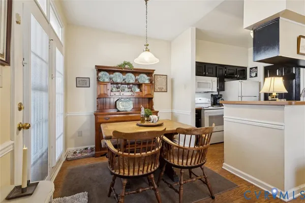 a dining room with furniture a chandelier and window