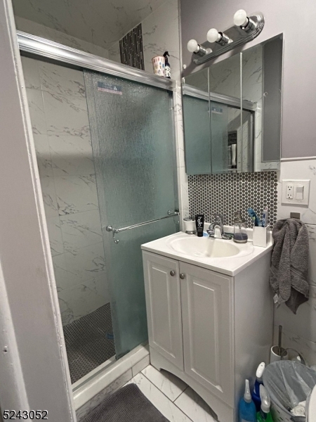 85 Eastern Way, Unit 2 Rutherford, NJ 07070 - Photo 11 of 14 a bathroom with a sink and mirror