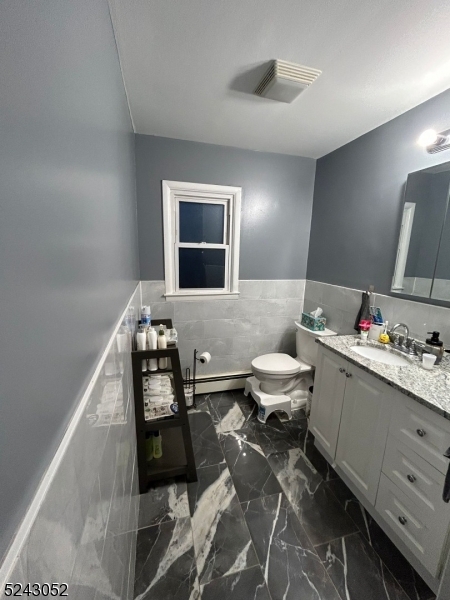 85 Eastern Way, Unit 2 Rutherford, NJ 07070 - Photo 12 of 14 a bathroom with a toilet sink and mirror