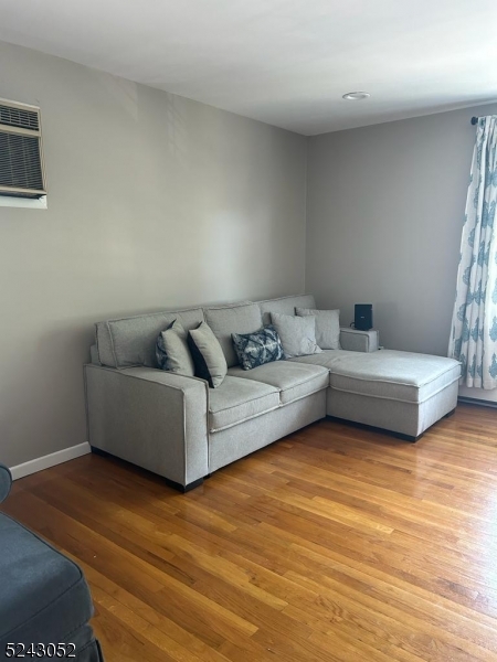 85 Eastern Way, Unit 2 Rutherford, NJ 07070 - Photo 2 of 14 a living room with furniture and a wooden floor