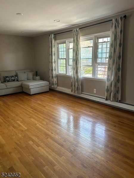 85 Eastern Way, Unit 2 Rutherford, NJ 07070 - Photo 3 of 14 a view of livingroom with furniture wooden floor and front door