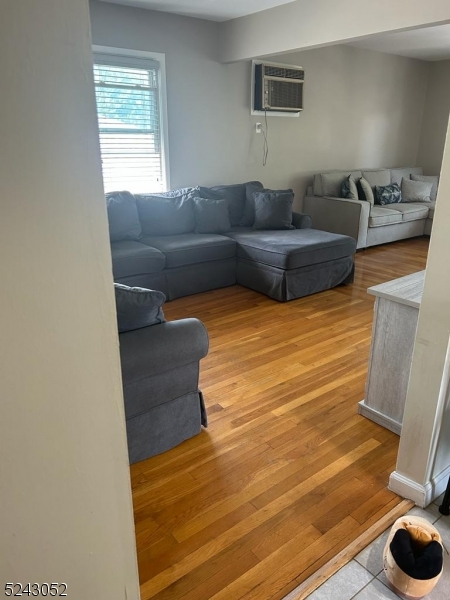 85 Eastern Way, Unit 2 Rutherford, NJ 07070 - Photo 4 of 14 a living room with furniture and a flat screen tv