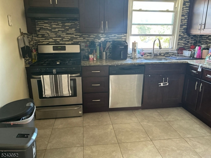 85 Eastern Way, Unit 2 Rutherford, NJ 07070 - Photo 5 of 14 a kitchen with a stove a sink and a cabinets