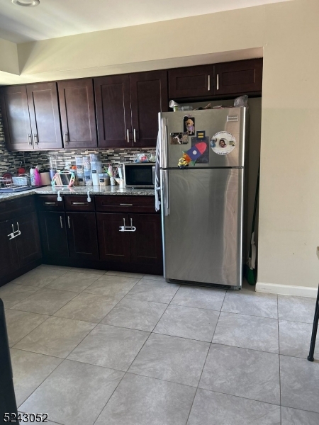 85 Eastern Way, Unit 2 Rutherford, NJ 07070 - Photo 6 of 14 a kitchen with stainless steel appliances granite countertop a refrigerator and a sink