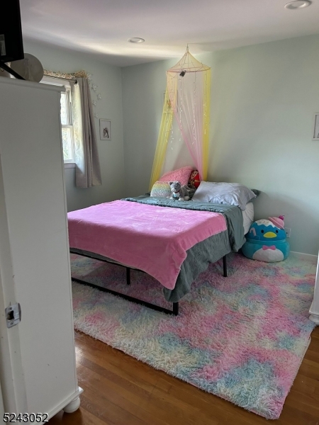 85 Eastern Way, Unit 2 Rutherford, NJ 07070 - Photo 8 of 14 a bedroom with a bed and a mirror