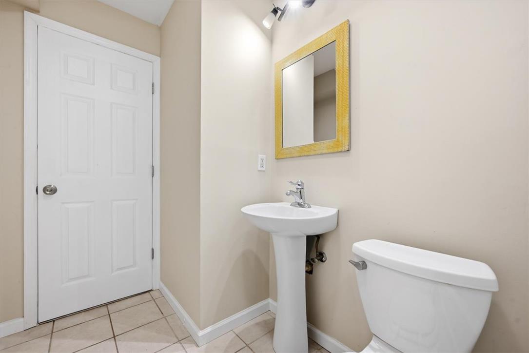 8761 Cascade Road Breinigsville, PA 18031 - Photo 48 of 84 A compact and functional lavatory features a pedestal sink and tile flooring, perfect for convenience.