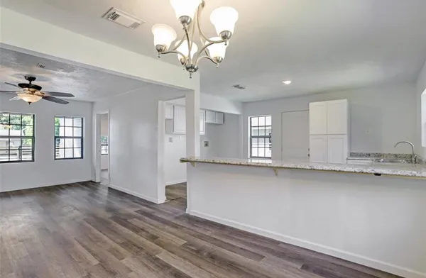 a view of kitchen with granite countertop cabinets a sink and dishwasher
