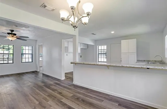 a view of kitchen with granite countertop cabinets a sink and dishwasher