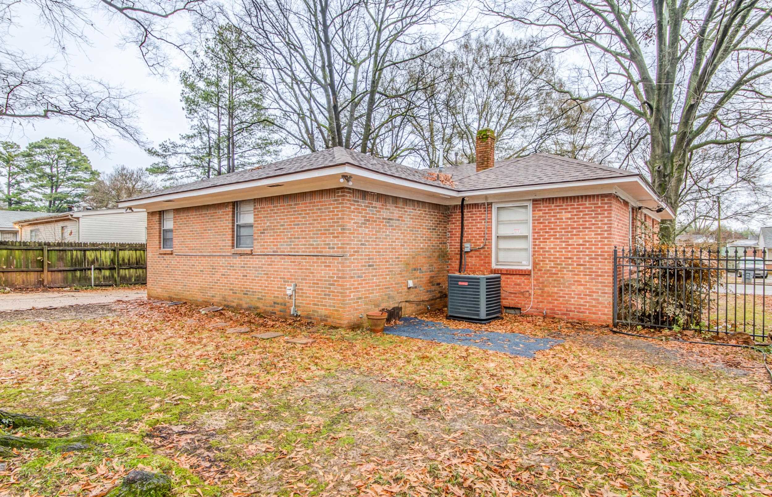 4850 Flamingo Road Memphis, TN 38117 - Photo 37 of 40 Rear view of house featuring brick siding, a chimney, and roof with shingles