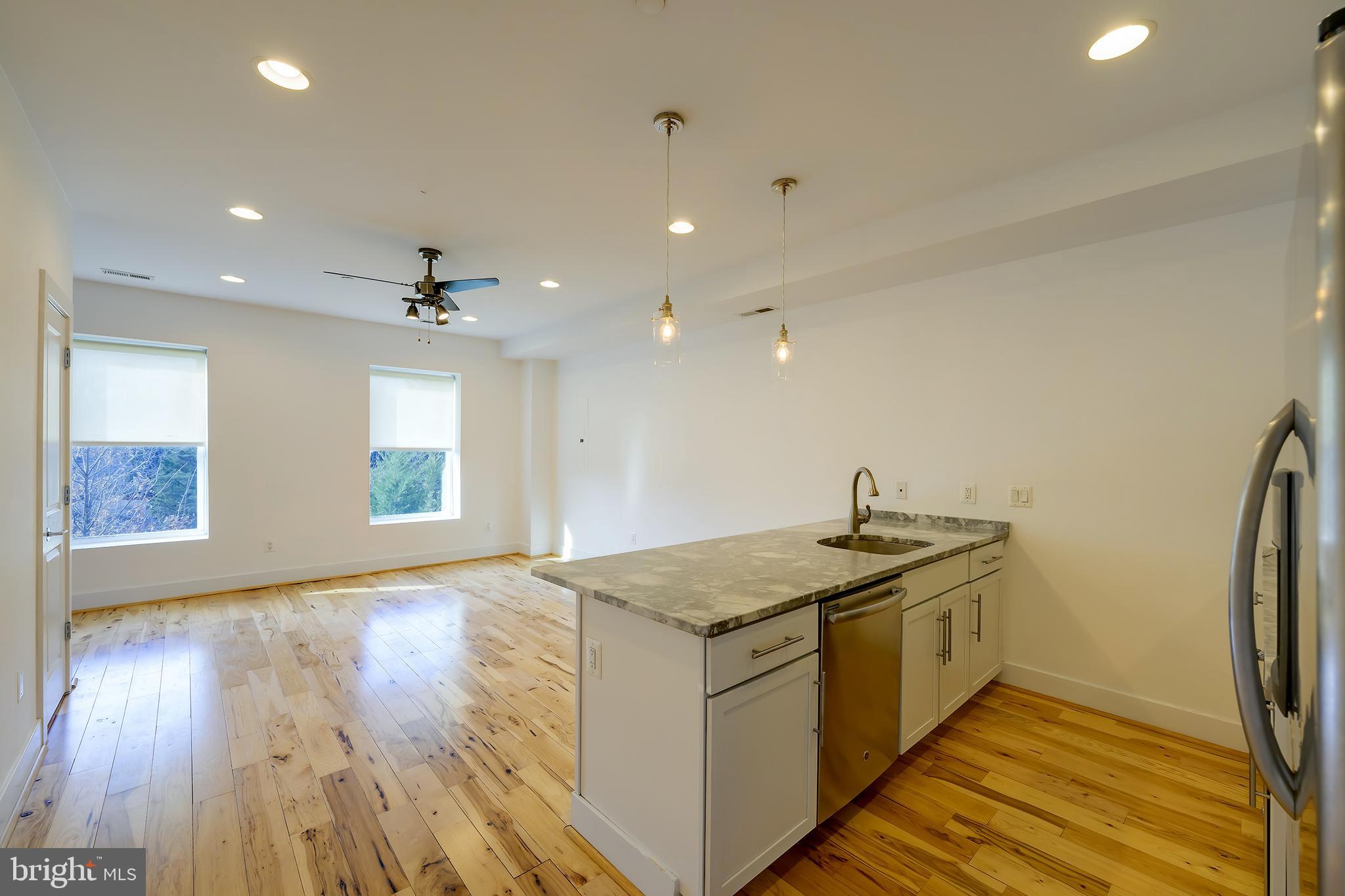 3325 11th Street Northwest, Unit 5 Washington, DC 20010 - Photo 3 of 25 a kitchen with a sink appliances and cabinets