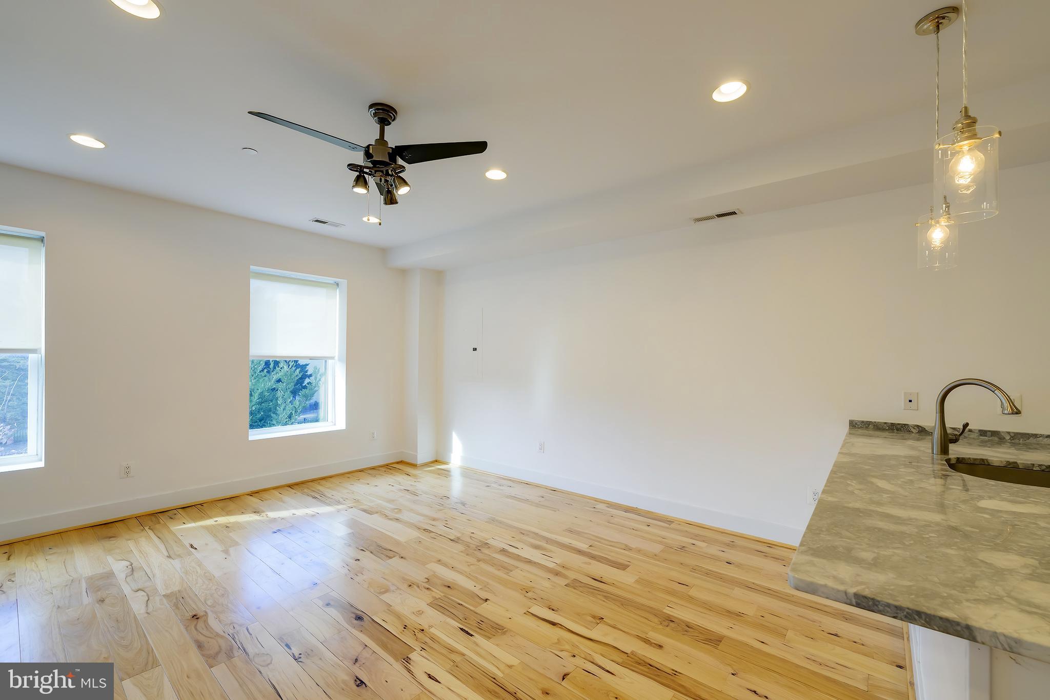 3325 11th Street Northwest, Unit 5 Washington, DC 20010 - Photo 5 of 25 a view of a livingroom with a chandelier fan and wooden floor