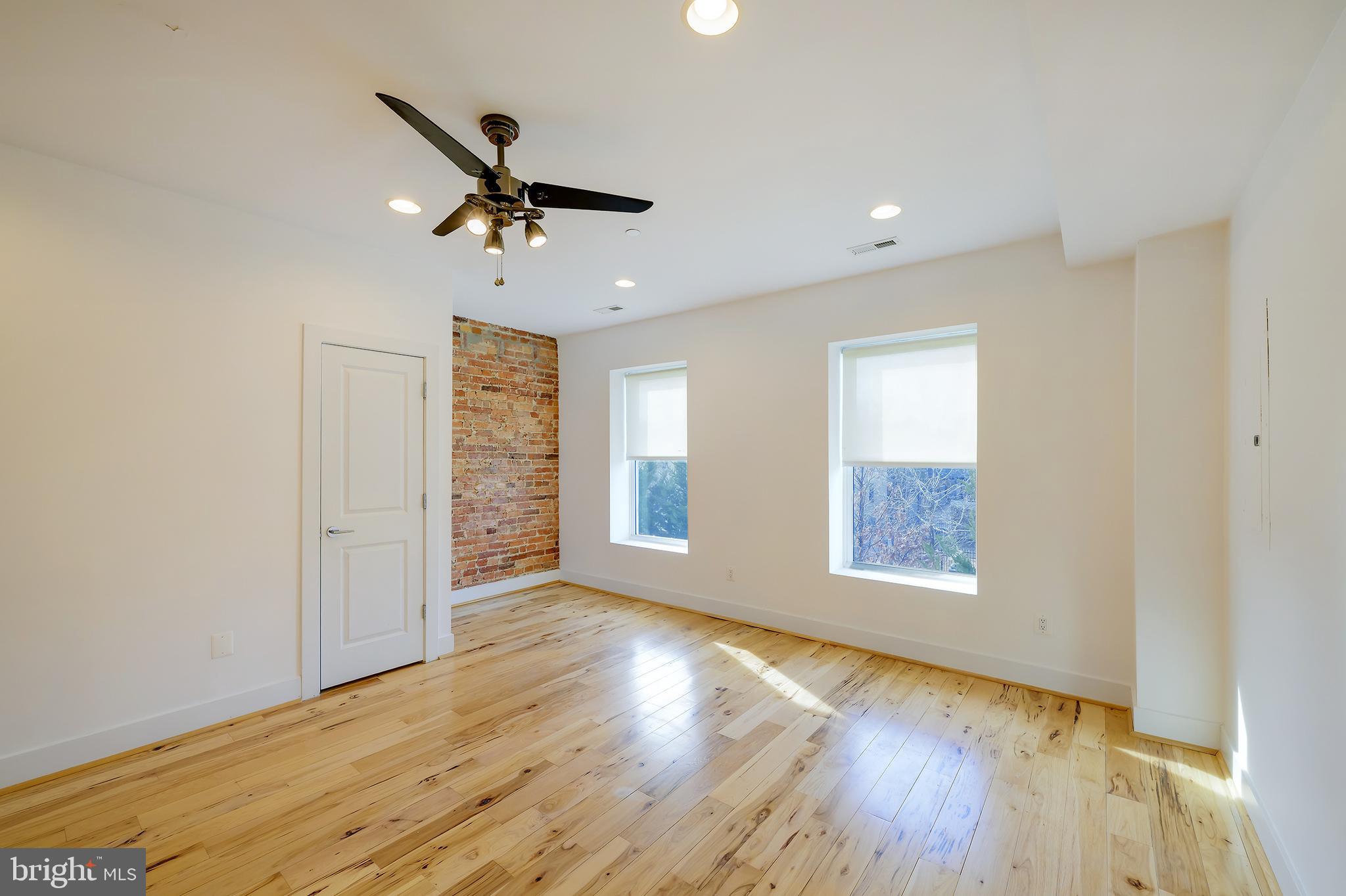 3325 11th Street Northwest, Unit 5 Washington, DC 20010 - Photo 9 of 25 a view of empty room with wooden floor and fan