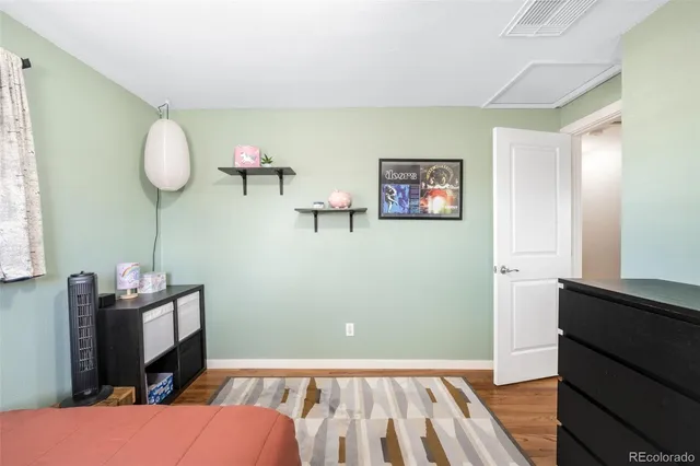 a view of a room with wooden floor and cabinet