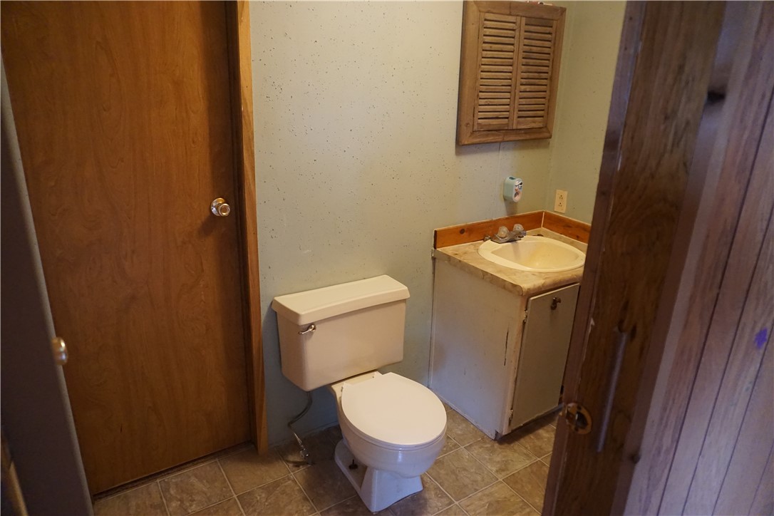 5765 Post Oak Loop Midway, TX 75852 - Photo 8 of 11 a white toilet sitting next to a bathroom sink