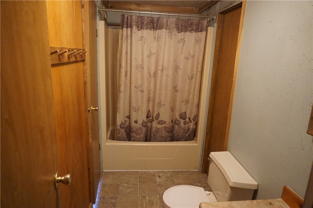 5765 Post Oak Loop Midway, TX 75852 - Photo 9 of 11 a bathroom with a shower curtain and sink