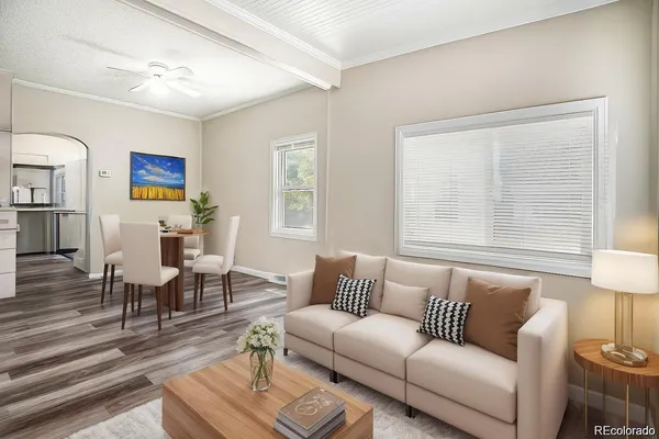 a living room with furniture wooden floor and a window