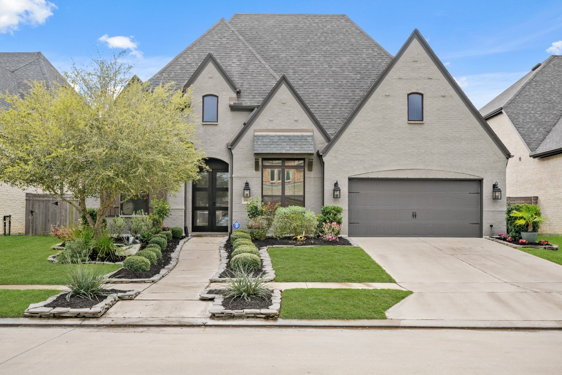 a front view of a house with a yard and garage