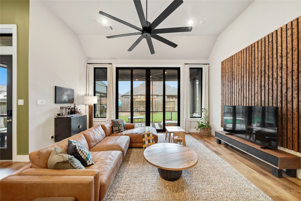 8902 Iron Forge Road Missouri City, TX 77459 - Photo 11 of 44 Family room with 13' ceilings. The 10' sliding doors open fully to the covered fully screened in patio. Enjoy indoor/outdoor entertainment.