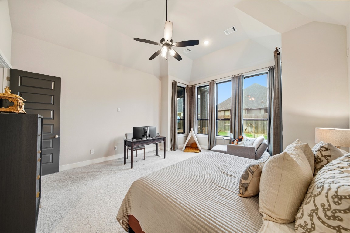 8902 Iron Forge Road Missouri City, TX 77459 - Photo 22 of 44 a bedroom with a bed and a chandelier