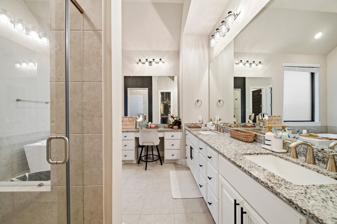 8902 Iron Forge Road Missouri City, TX 77459 - Photo 25 of 44 a spacious bathroom with a granite countertop sink a mirror and a shower