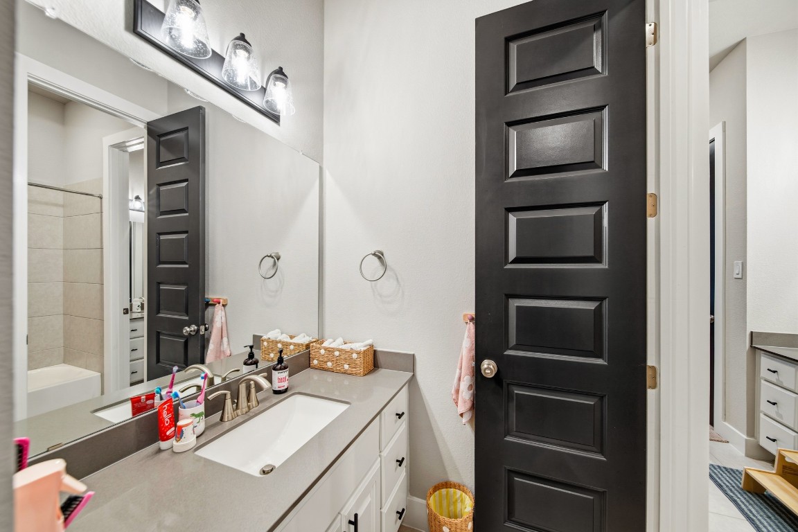 8902 Iron Forge Road Missouri City, TX 77459 - Photo 35 of 44 a bathroom with a sink double vanity and a mirror