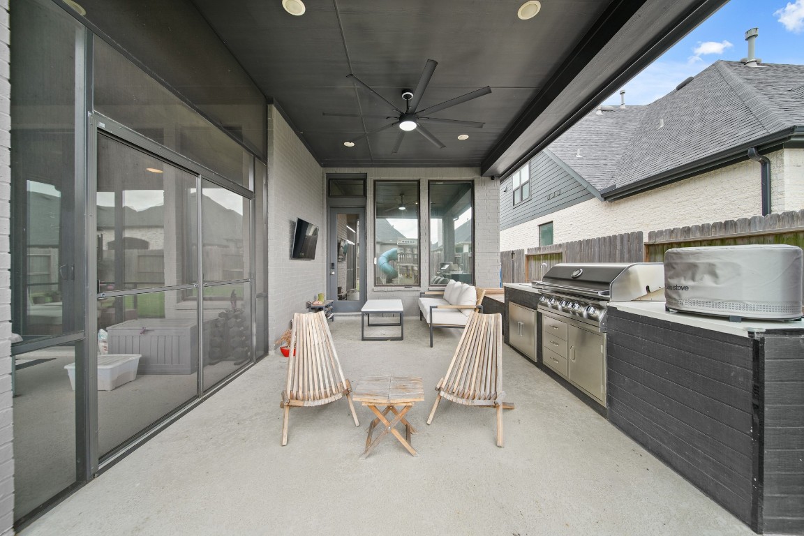 8902 Iron Forge Road Missouri City, TX 77459 - Photo 41 of 44 a dining room with furniture and a floor to ceiling window