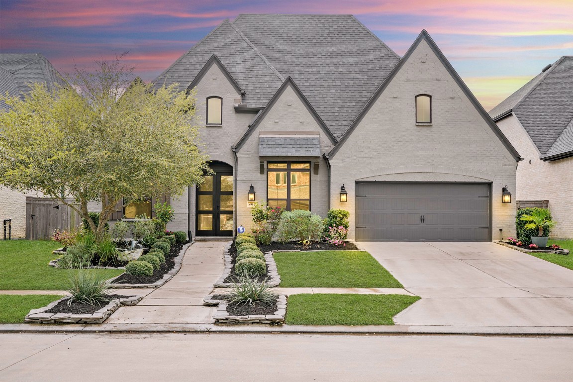 8902 Iron Forge Road Missouri City, TX 77459 - Photo 43 of 44 a front view of a house with a yard and garage