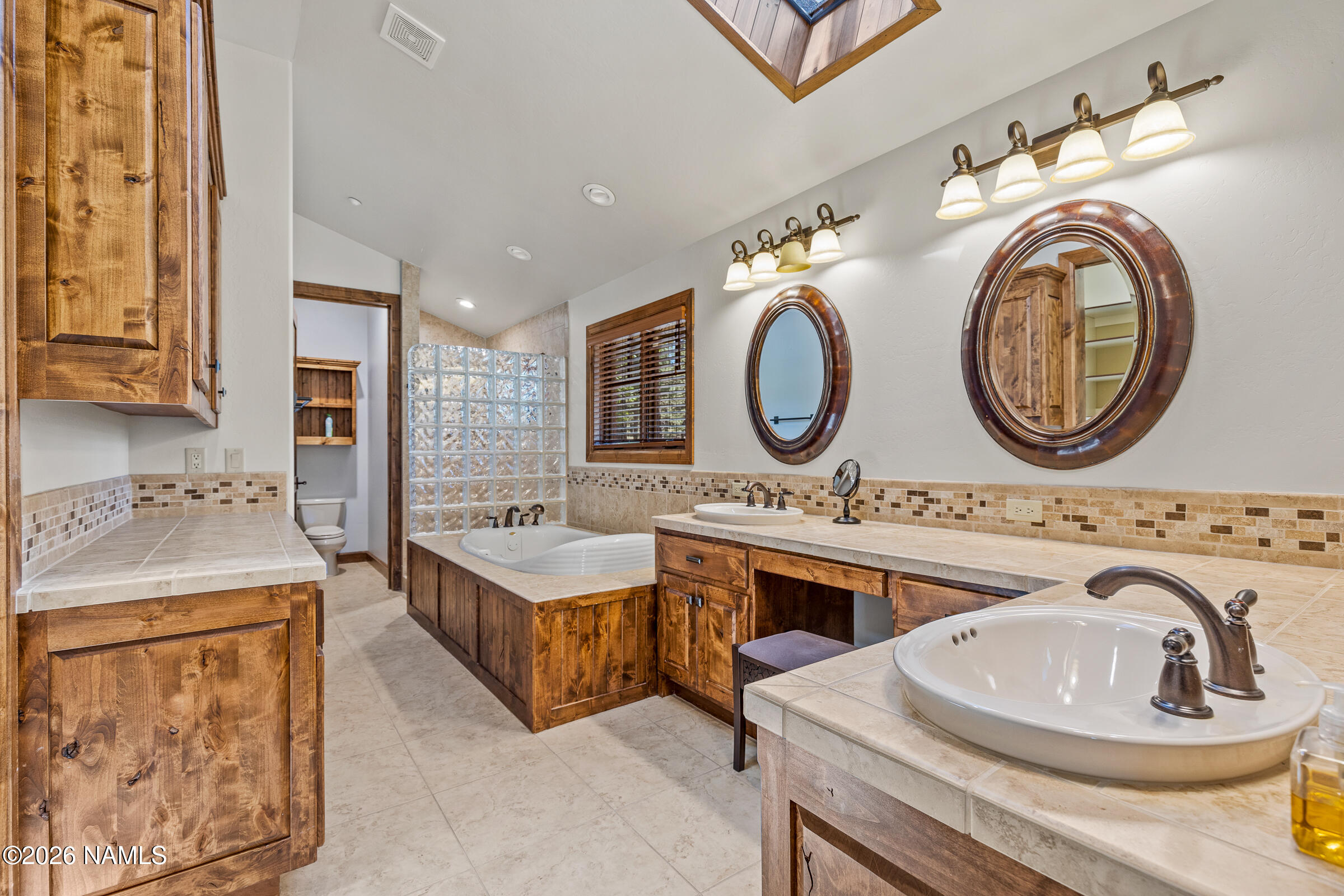 2214 East Del Rae Drive Flagstaff, AZ 86005 - Photo 17 of 45 a bathroom with a toilet a sink and a mirror