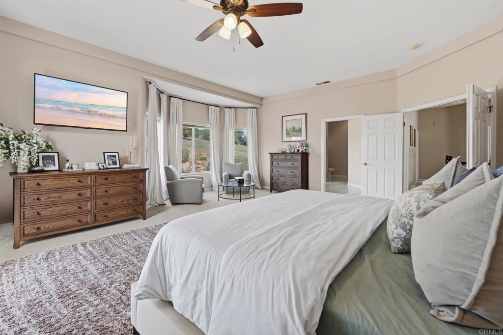 2852 Conestoga Court Alpine, CA 91901 - Photo 30 of 65 a spacious bedroom with a bed and wooden floor