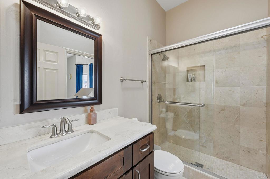 2852 Conestoga Court Alpine, CA 91901 - Photo 38 of 65 a bathroom with a sink a toilet and shower a mirror