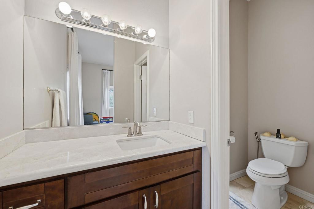 2852 Conestoga Court Alpine, CA 91901 - Photo 43 of 65 a bathroom with a sink a toilet a mirror and shower