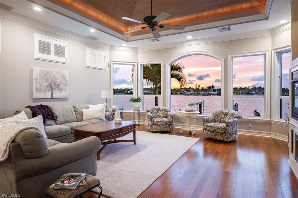 1942 Kingfish Road Naples, FL 34102 - Photo 8 of 43 a living room with furniture floor to ceiling window and wooden floor