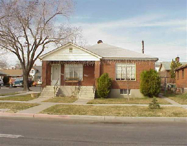 a view of a house with a patio and a yard