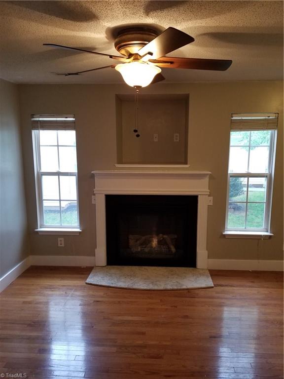 315 Apple Ridge Road Greensboro, NC 27406 - Photo 7 of 22 Living room w/natural light and fireplace