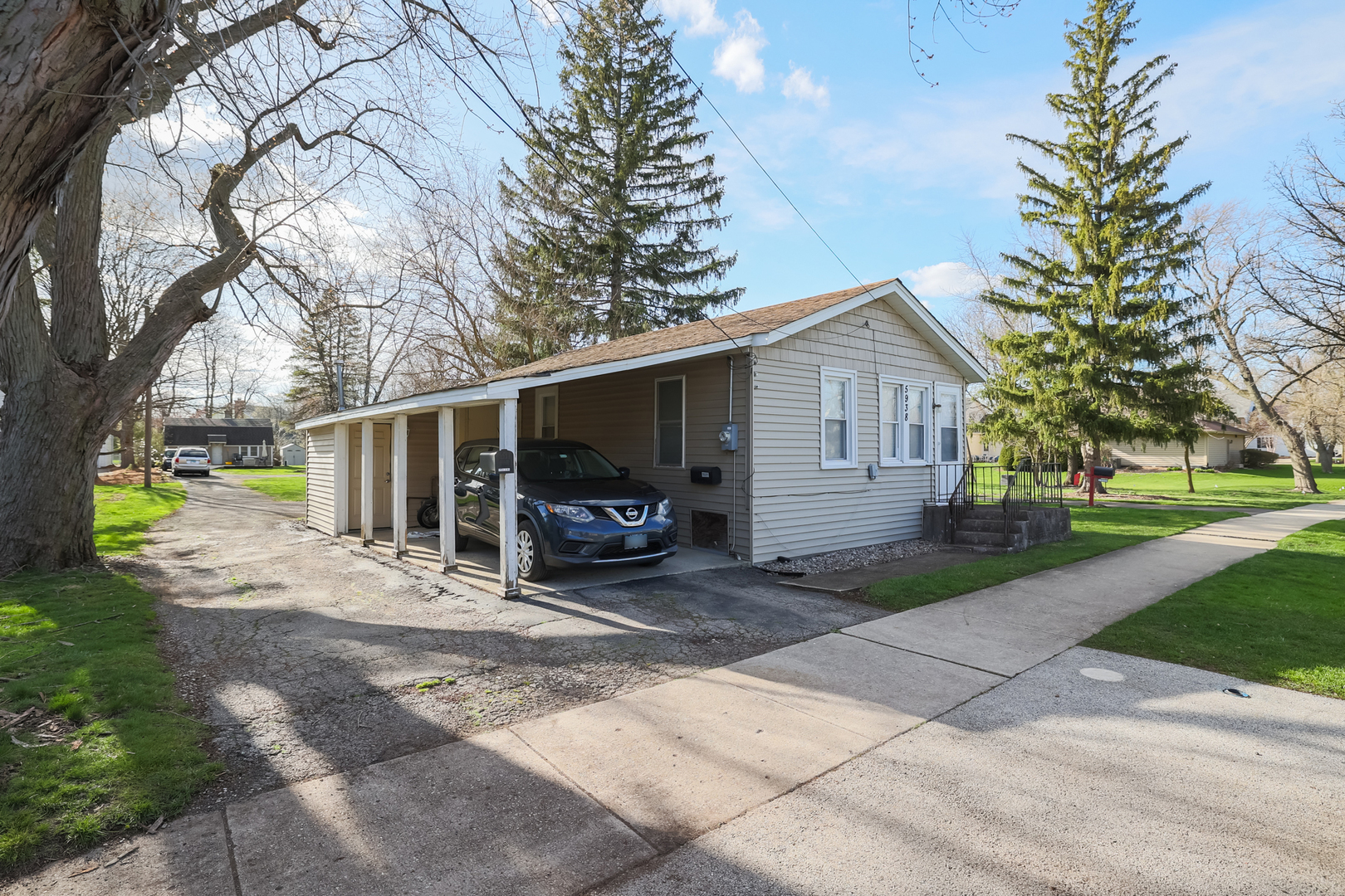 5938 Dunham Road Downers Grove, IL 60516 - Photo 1 of 11 a view of a house with a patio and a yard