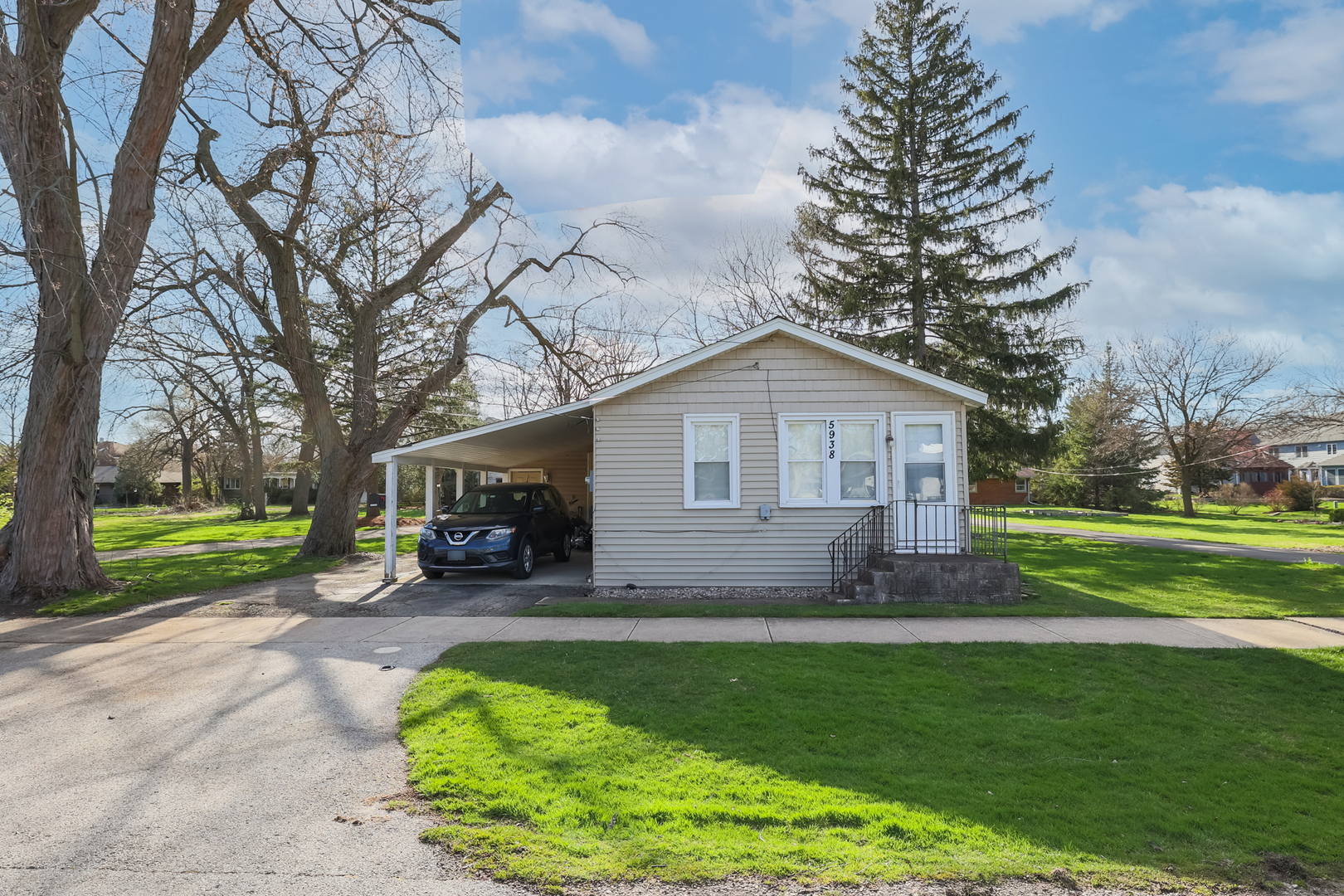 5938 Dunham Road Downers Grove, IL 60516 - Photo 2 of 11 a front view of house with yard and green space