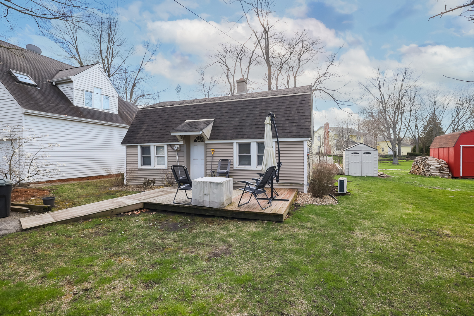 5938 Dunham Road Downers Grove, IL 60516 - Photo 7 of 11 a front view of a house with a garden and swimming pool