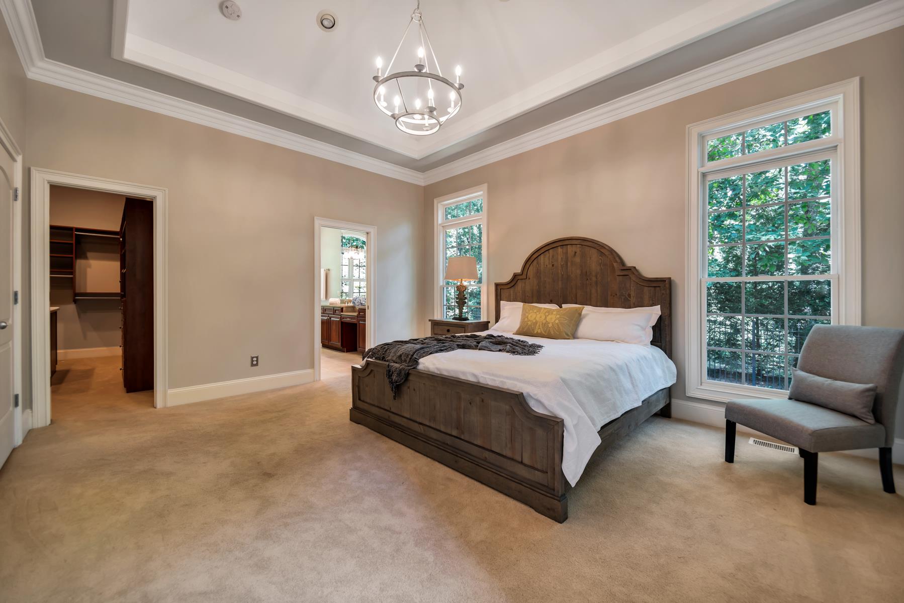 4006 Harding Place Nashville, TN 37215 - Photo 17 of 30 a bedroom with a large bed and a chandelier