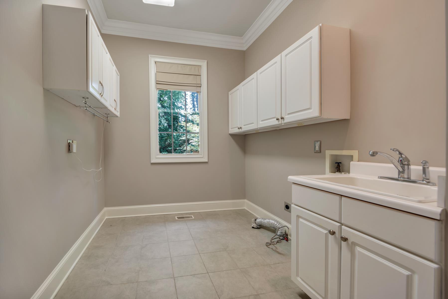 4006 Harding Place Nashville, TN 37215 - Photo 26 of 30 a room with a sink cabinets and utility