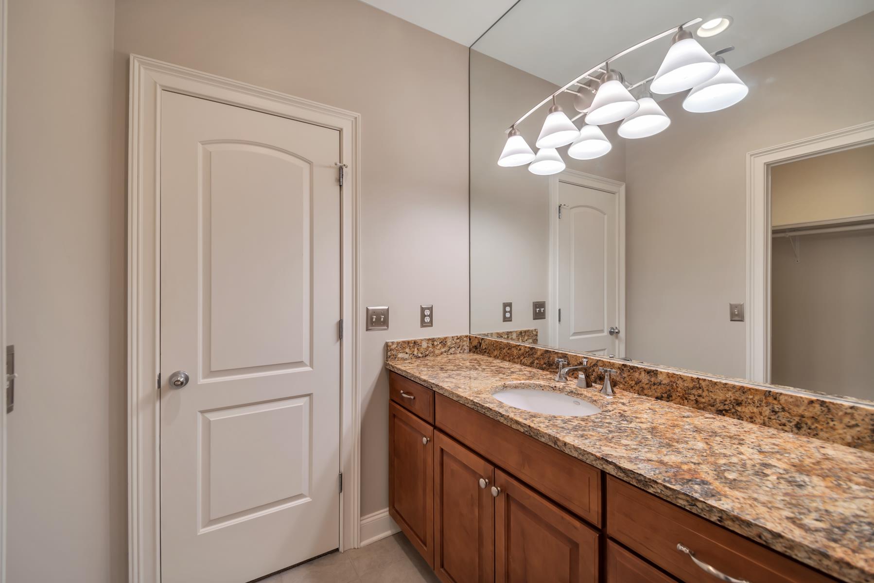 4006 Harding Place Nashville, TN 37215 - Photo 27 of 30 a bathroom with a granite countertop sink and a mirror