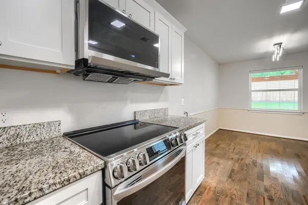 a kitchen with a stove and a microwave