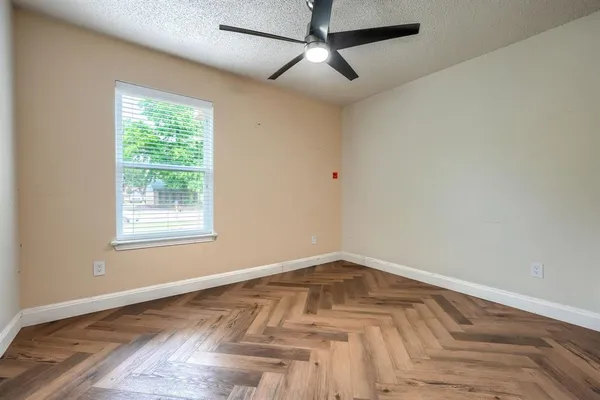 a view of a room with wooden floor and windows