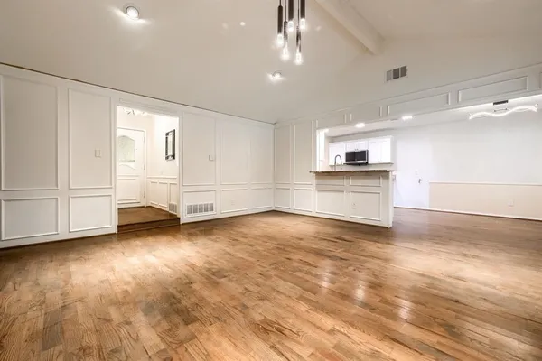 a view of an empty room with a kitchen