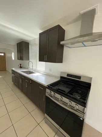 a kitchen with stainless steel appliances granite countertop a stove and a sink